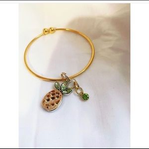 A gold colored bracelet with a pineapple 🍍❕💓
